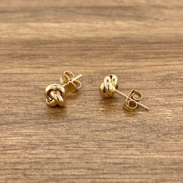 Gold knot stud earrings.
