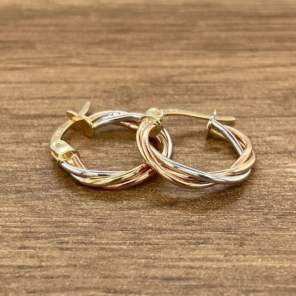 Tri-tone gold twisted hoop earrings.