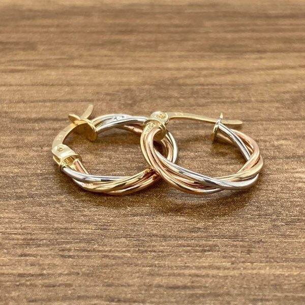 Tri-tone gold twisted hoop earrings.