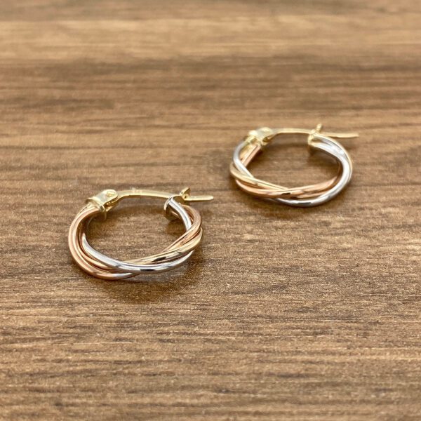 Tri-tone gold twisted hoop earrings.