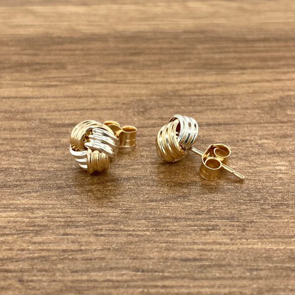 Gold and silver knot earrings.