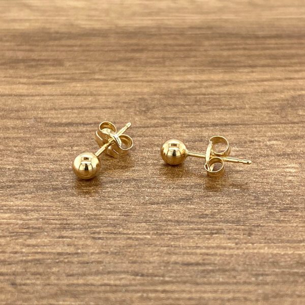 Pair of gold ball stud earrings.