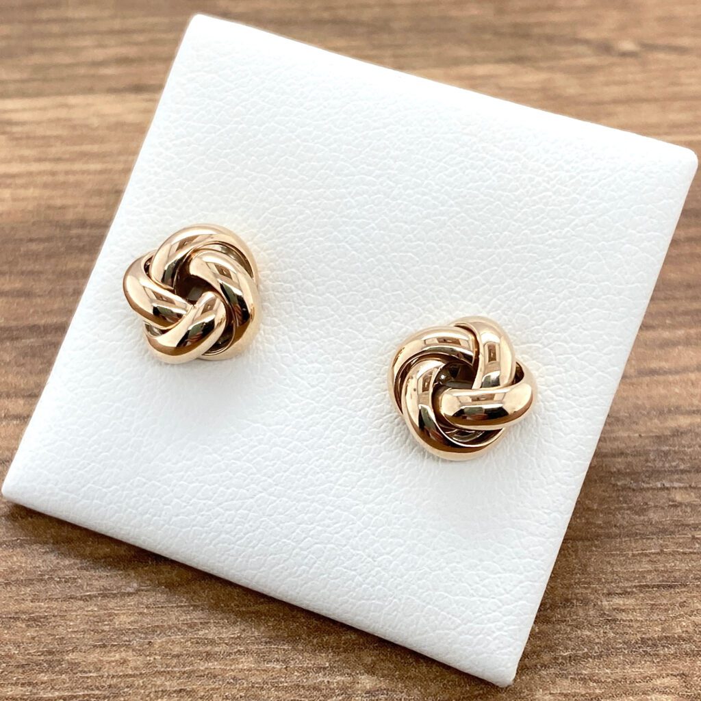 Gold knot stud earrings.