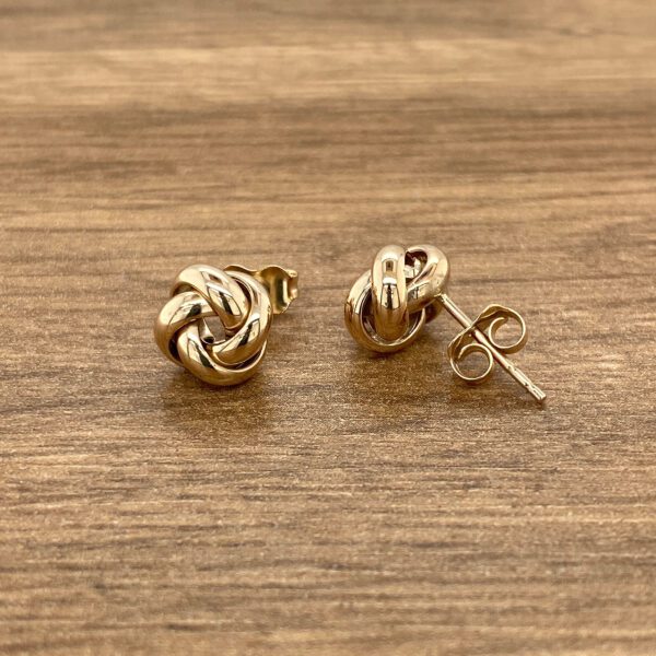 Gold knot stud earrings.
