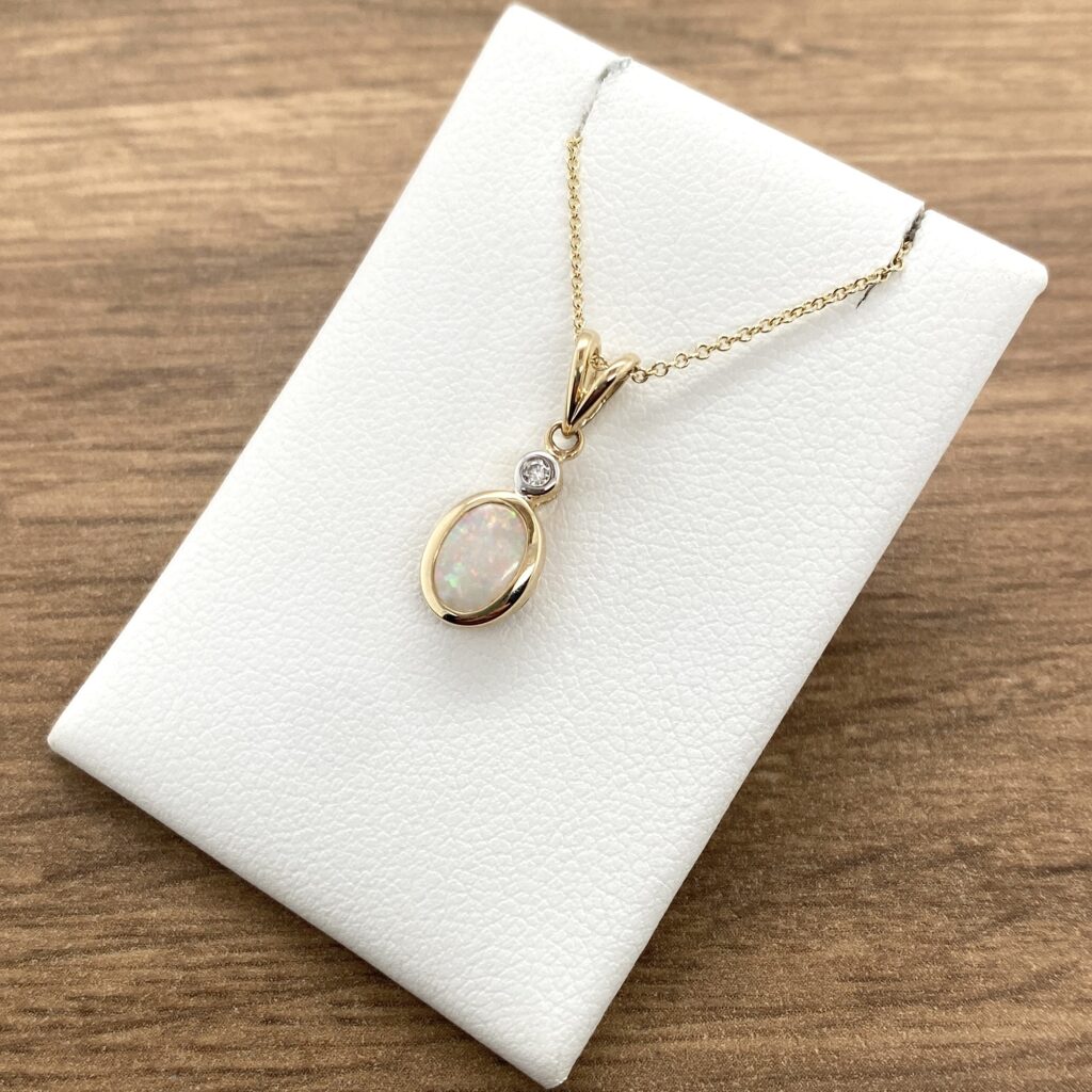 Gold opal and diamond pendant necklace.