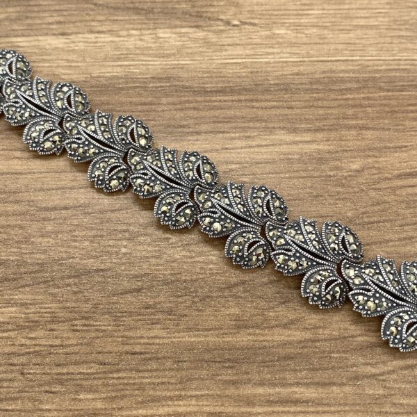 Marcasite leaf bracelet on wood.
