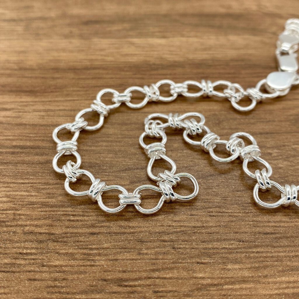 Silver chain necklace, knotted links.