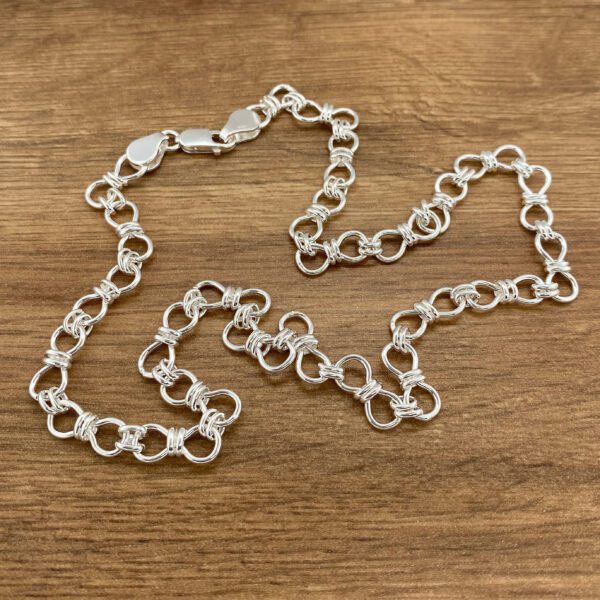 Silver chain necklace, knotted design.