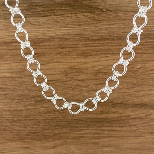 Silver infinity knot necklace.