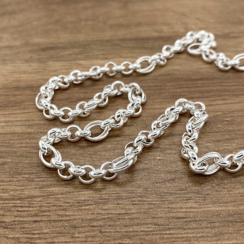 Silver chain necklace on wood.