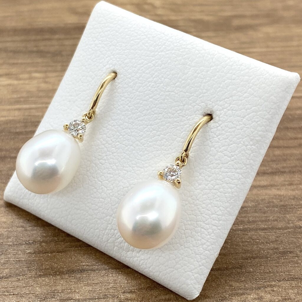 Elegant pearl and diamond drop earrings.