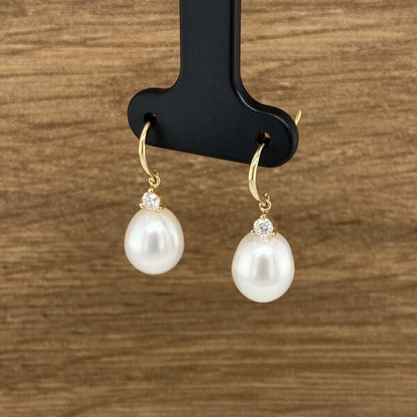 Elegant pearl and diamond drop earrings.