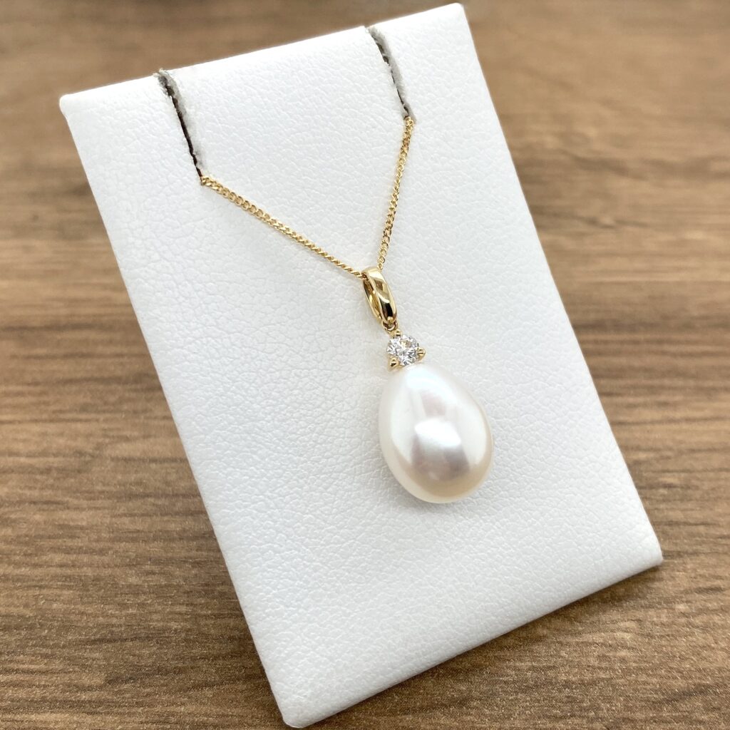 Elegant pearl and diamond pendant necklace.