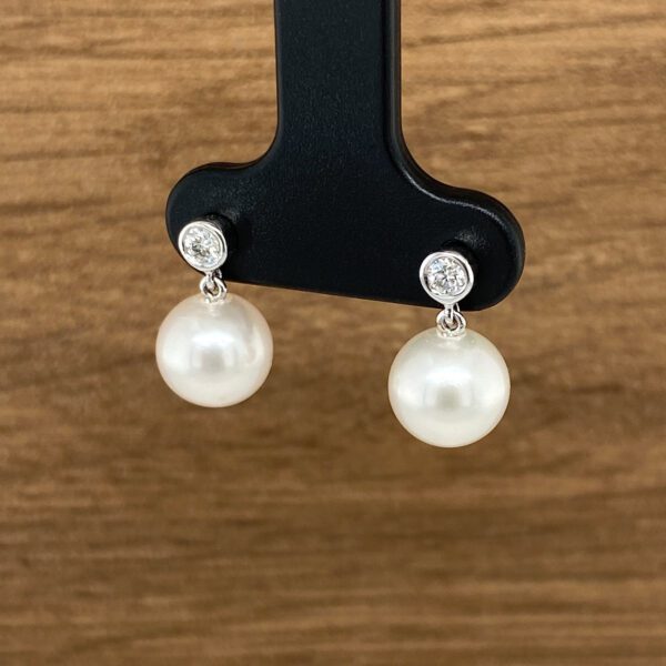 Elegant pearl and diamond earrings.