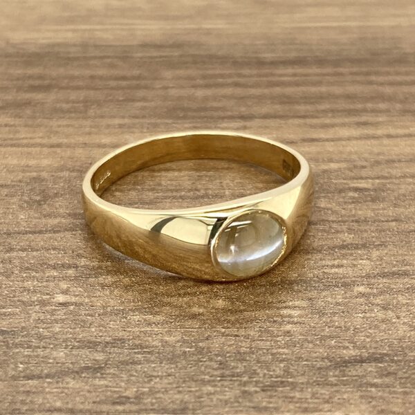 Gold signet ring with cabochon stone.