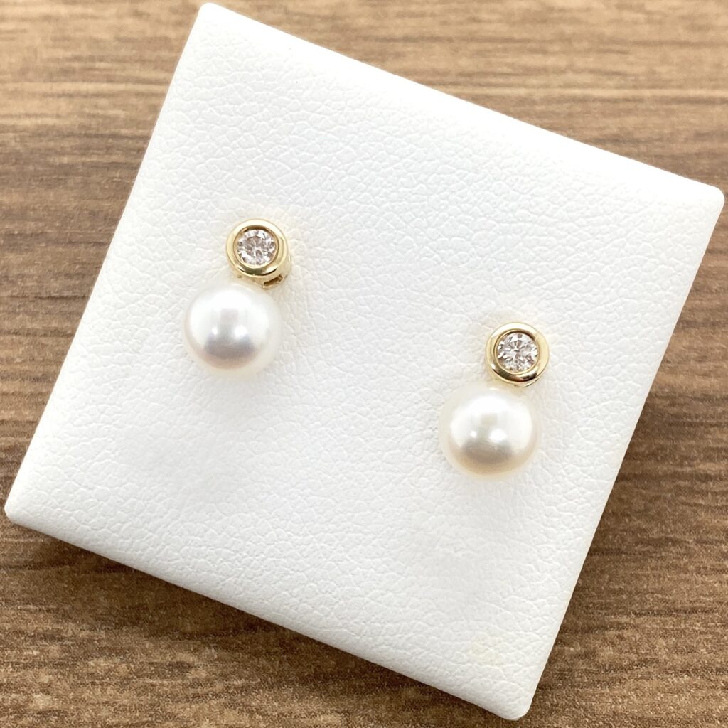 Pearl and diamond stud earrings.