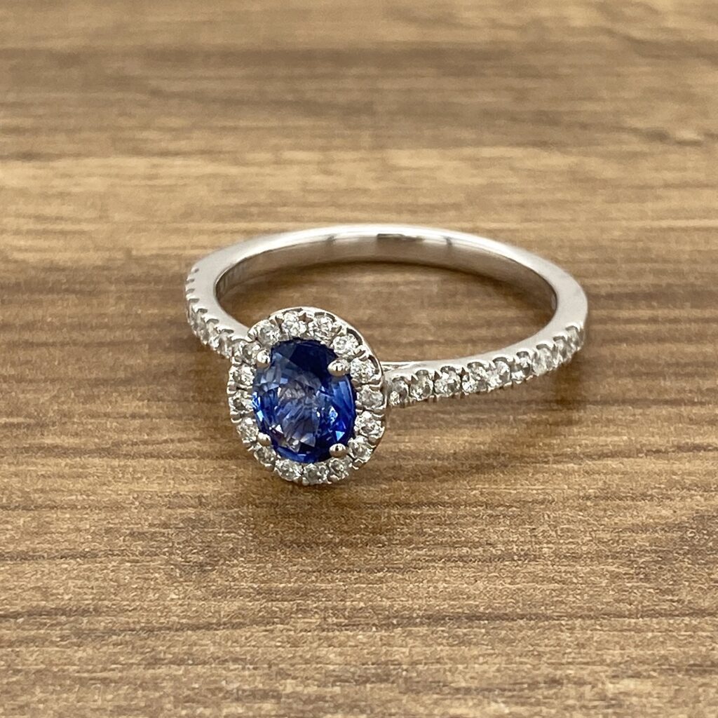 Oval sapphire ring with diamond halo.