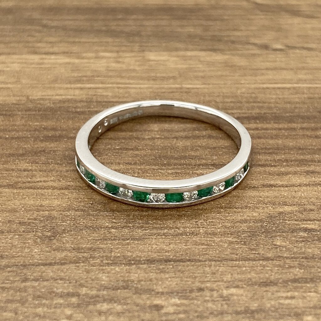 Emerald and diamond eternity band ring.