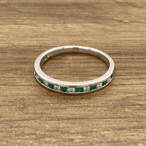 Emerald and diamond eternity band ring.