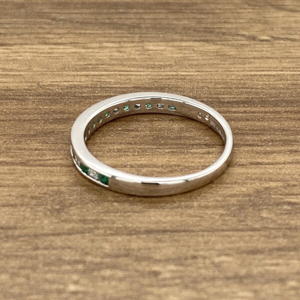 Emerald and diamond eternity band ring.