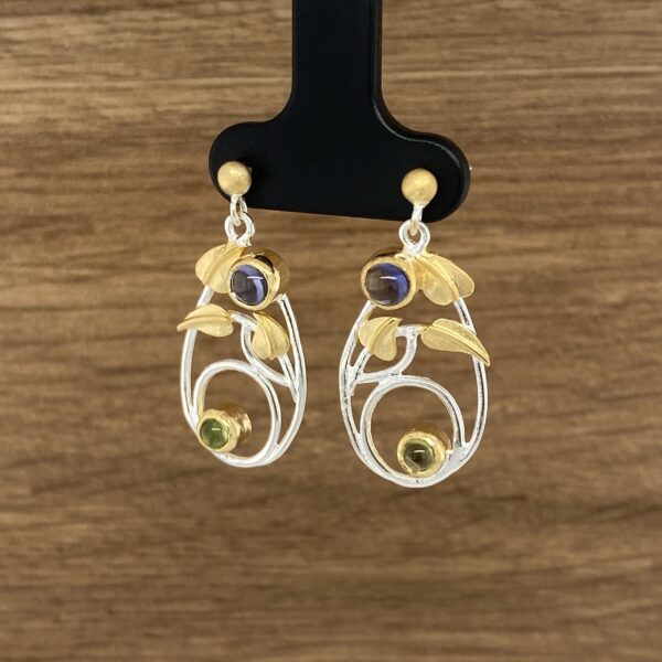 Elegant gemstone earrings with leaf design.
