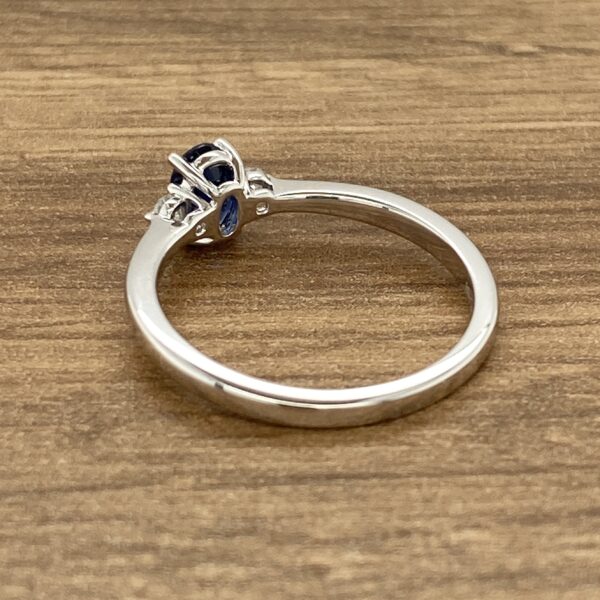 Silver ring with blue sapphire and diamonds.