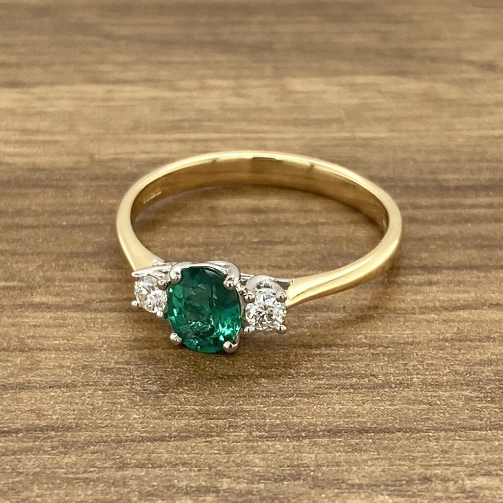 Gold ring with emerald and diamonds.