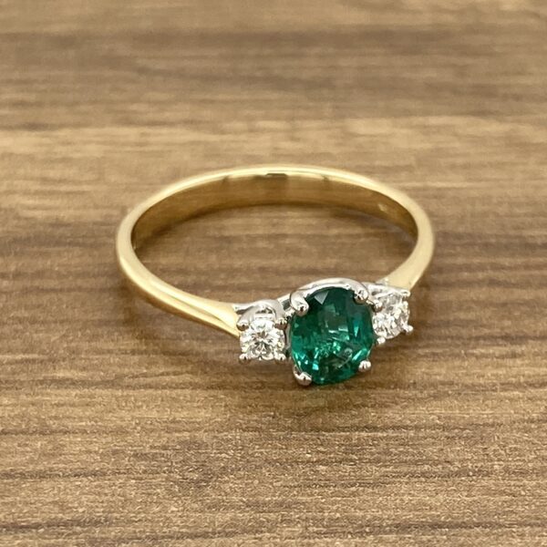 Gold ring with emerald and diamonds.
