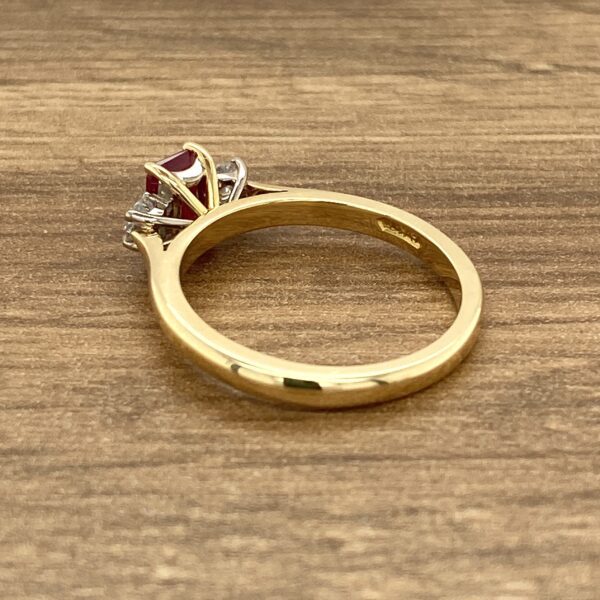 Gold ruby and diamond three-stone ring.