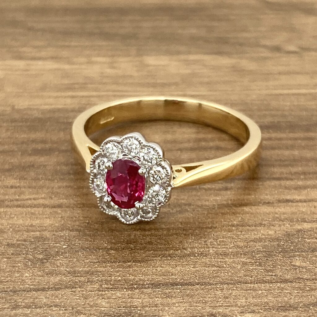Gold ruby ring with diamond halo.