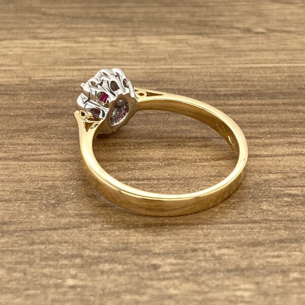 Gold ring with ruby and diamond cluster.