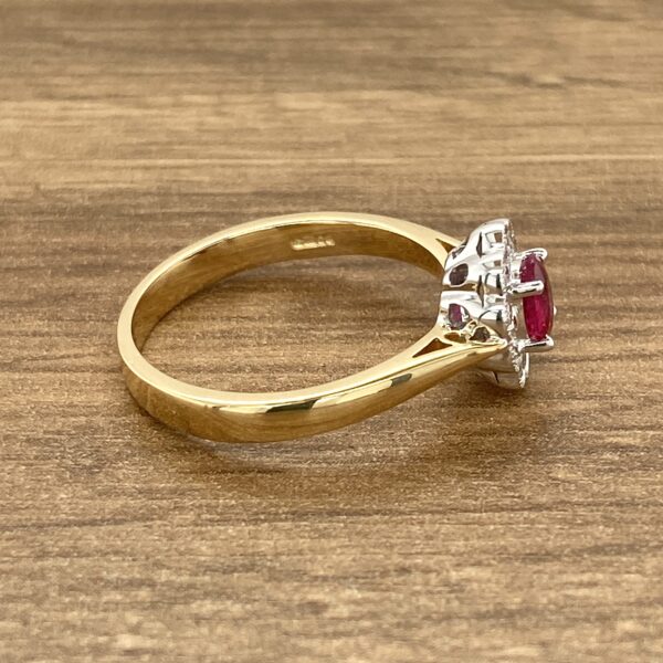 Gold ruby and diamond ring side view.