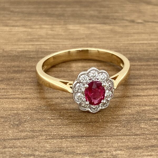 Gold ruby ring with diamond halo.