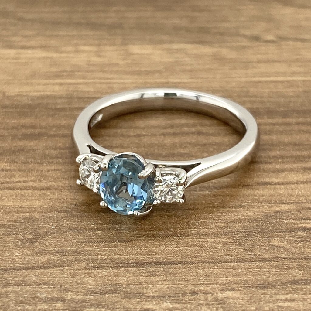 Three-stone ring with blue sapphire.