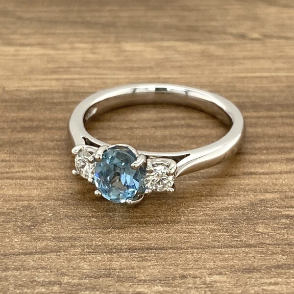 Three-stone ring with blue sapphire.