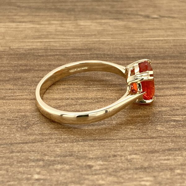 Gold ring with orange opal gemstone.