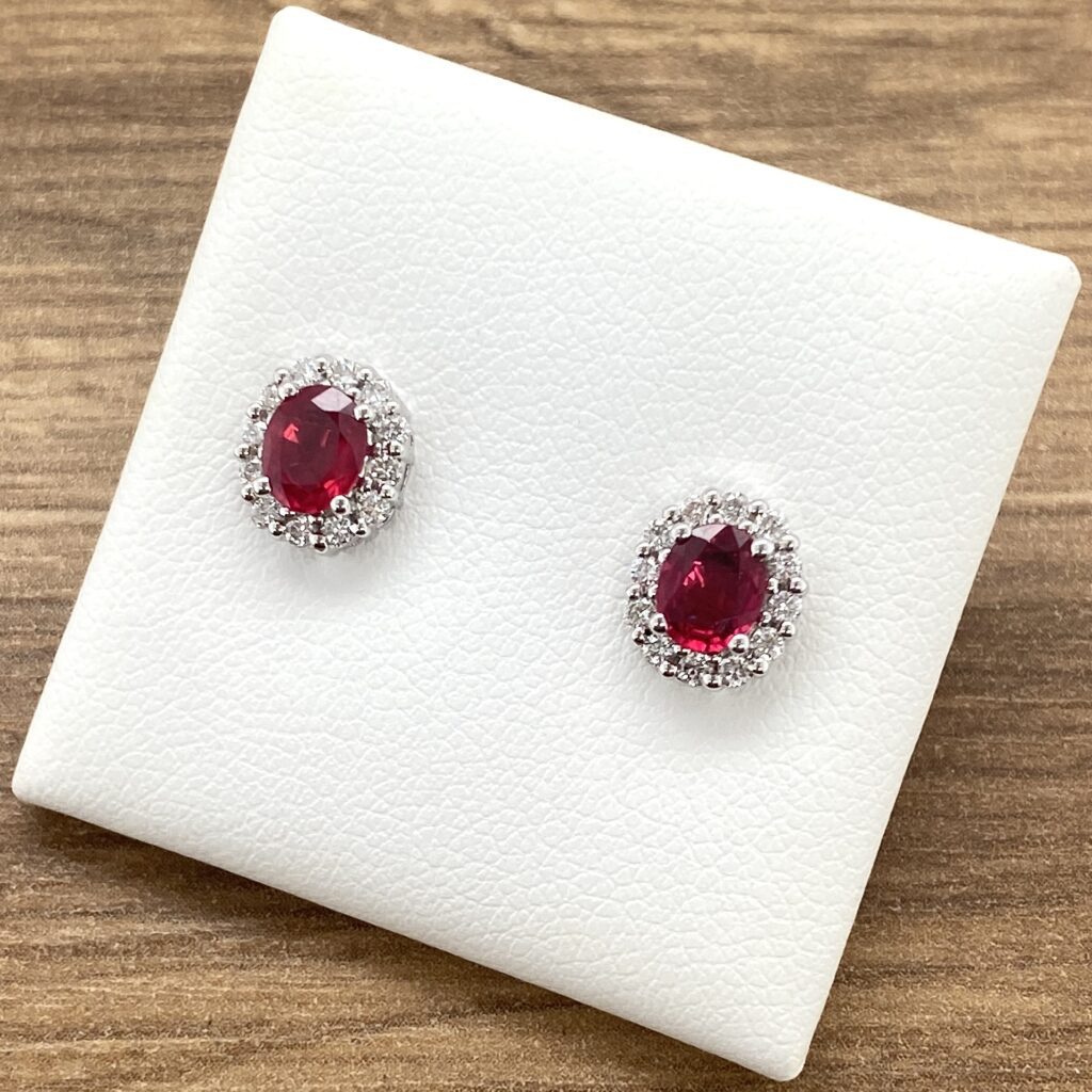 Ruby and diamond halo stud earrings.