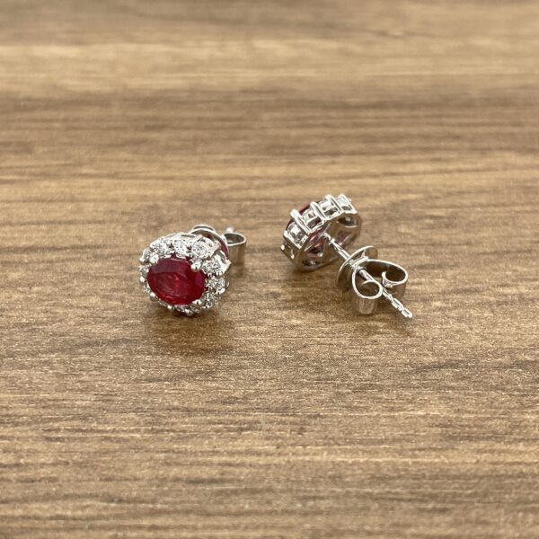 Ruby and diamond halo stud earrings.