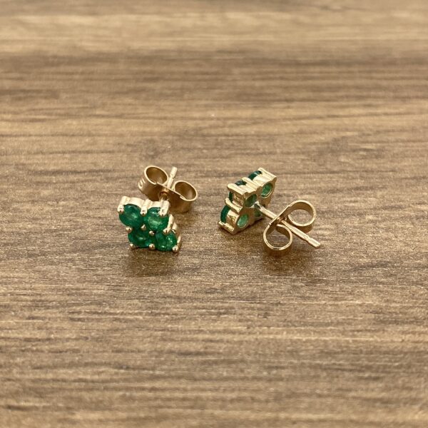Gold emerald cluster stud earrings.