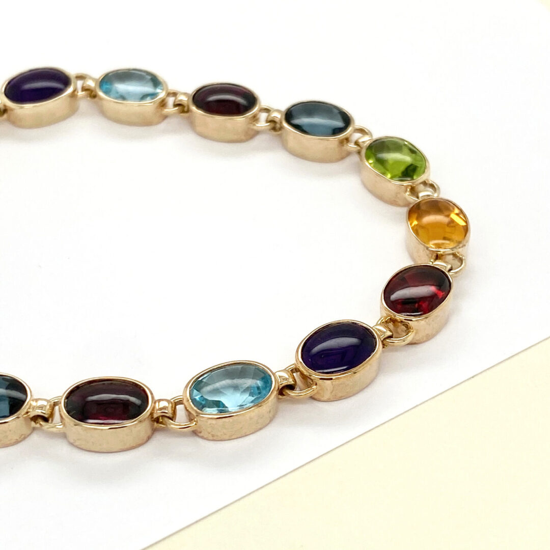 Gold bracelet with colorful gemstones.