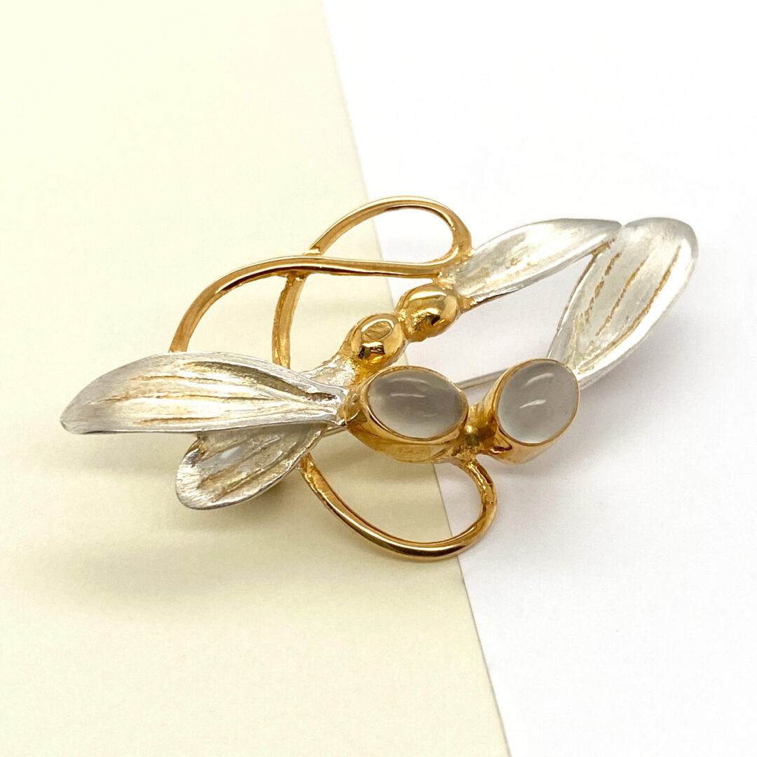 Gold and silver dragonfly brooch with stones.