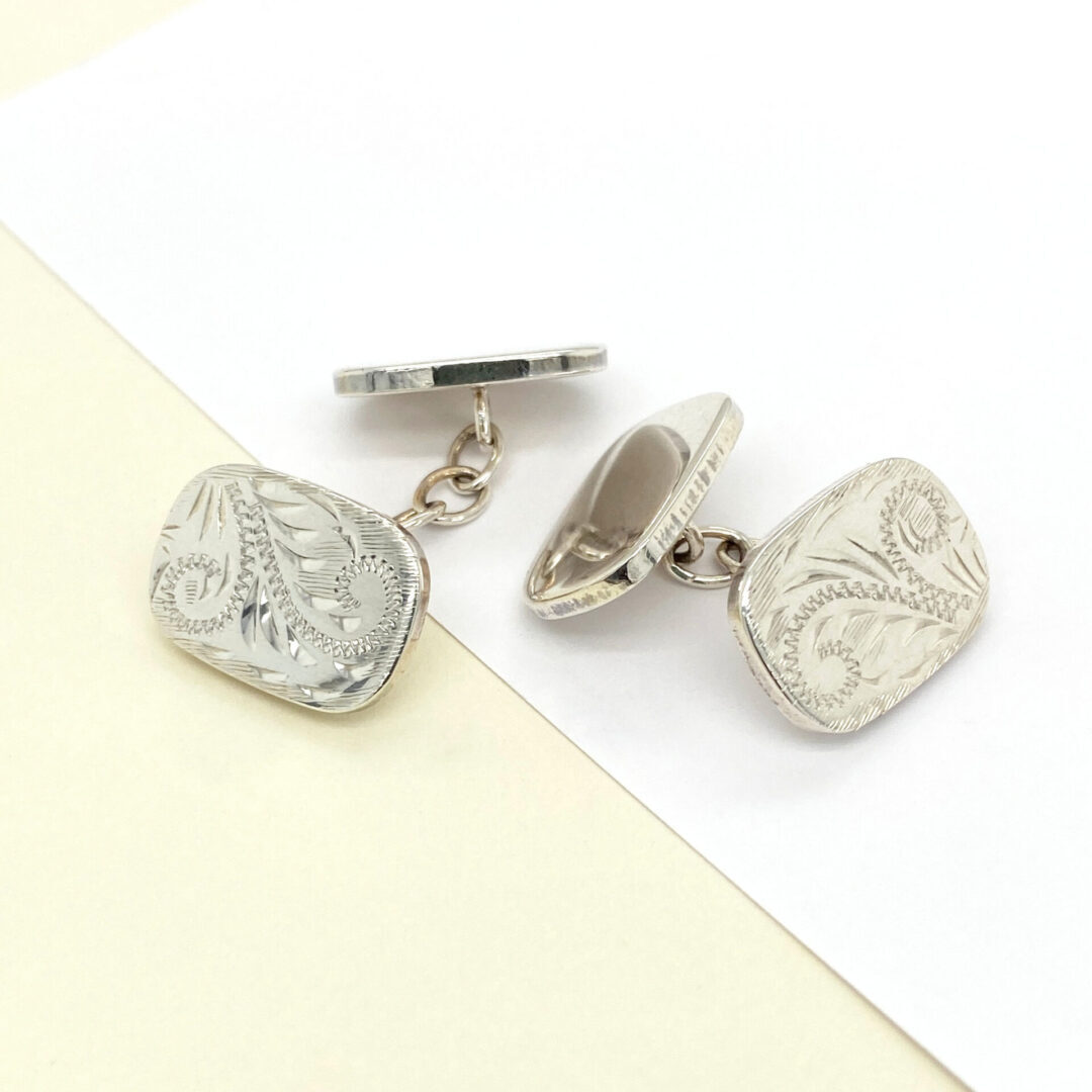 Silver cufflinks with engraved design.