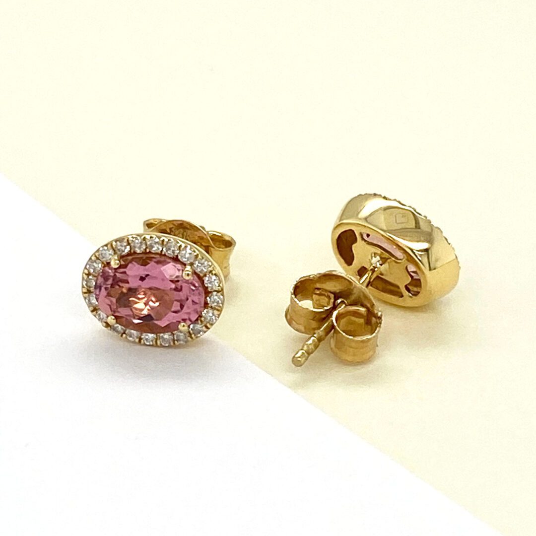 Pink gemstone and diamond earrings.