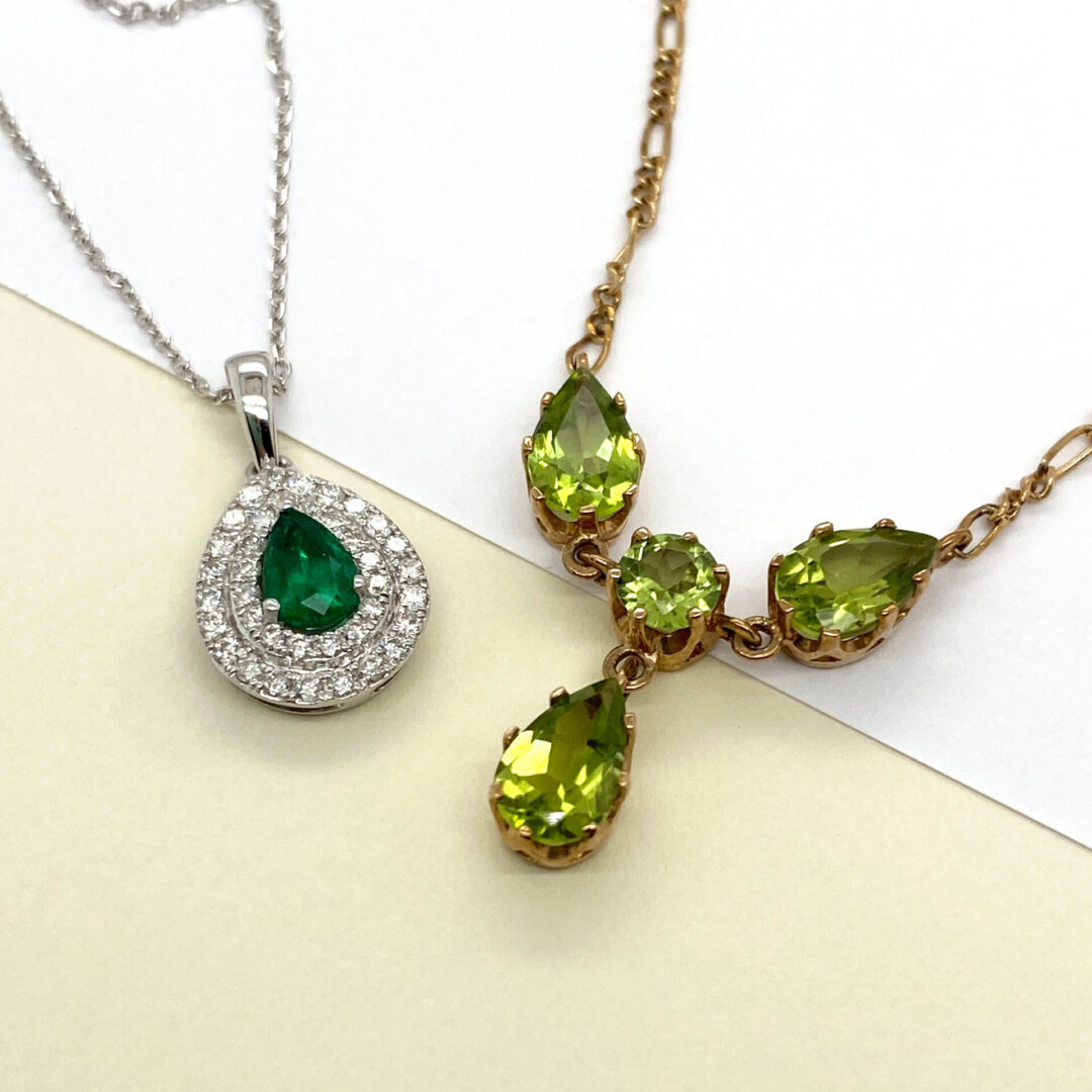 Two necklaces with green gemstones.