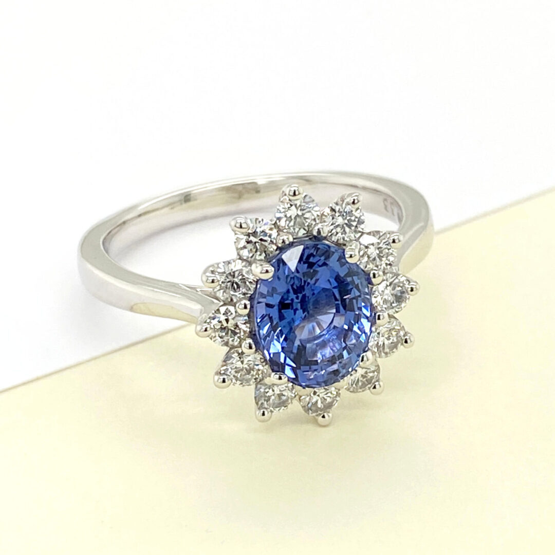 Diamond halo ring with blue sapphire gemstone.